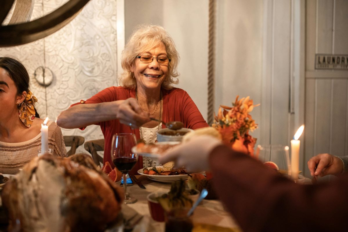 Elderly woman enjoying dinner