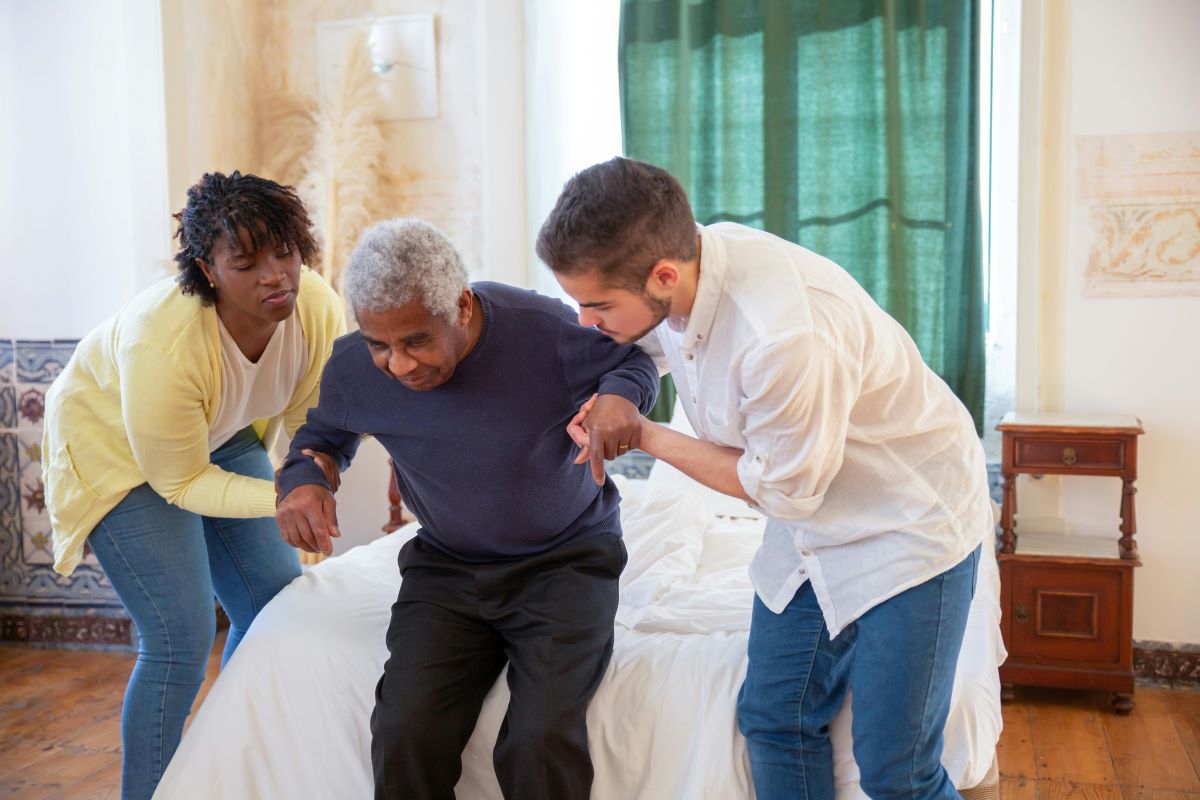Elderly man getting assistance standing up
